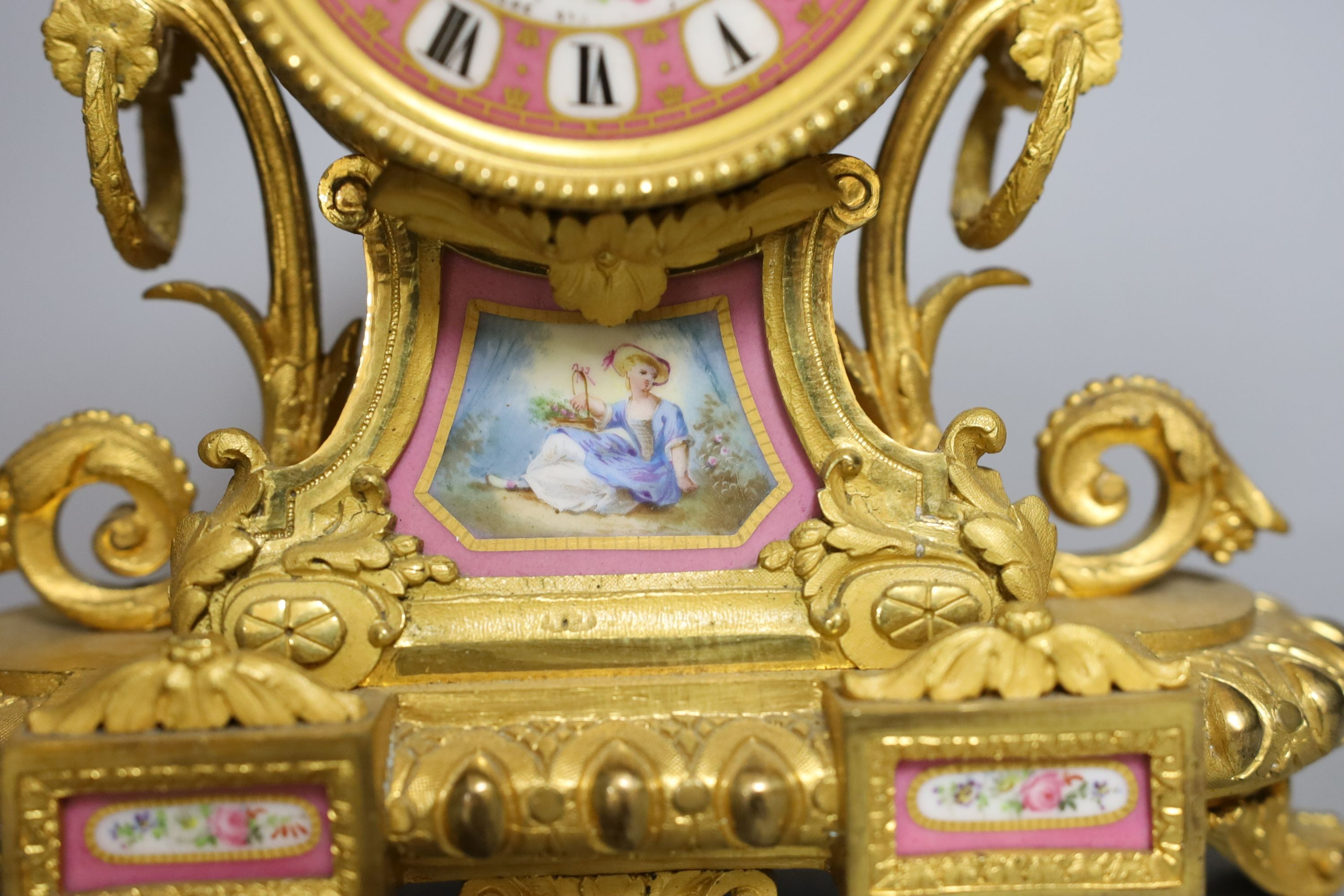 A French ormolu mantel clock with Sevres style panels. Height 29cm